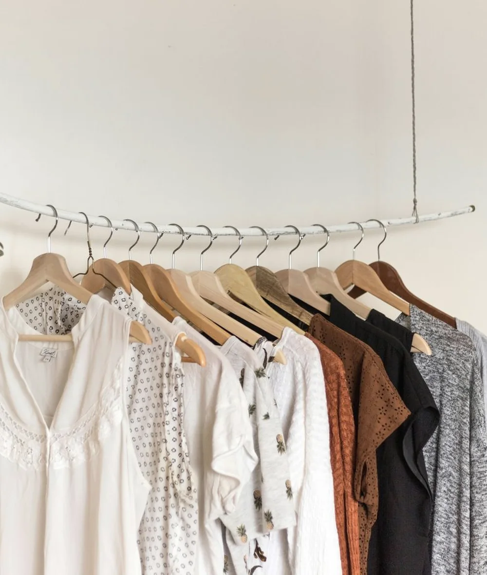 Lightweight natural-toned clothing layers arranged on a rail
